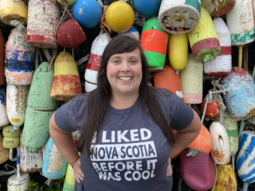 cailin wearing an i liked nova scotia before it was cool tshirt at the yarmouth buoy wall on the yarmouth bar